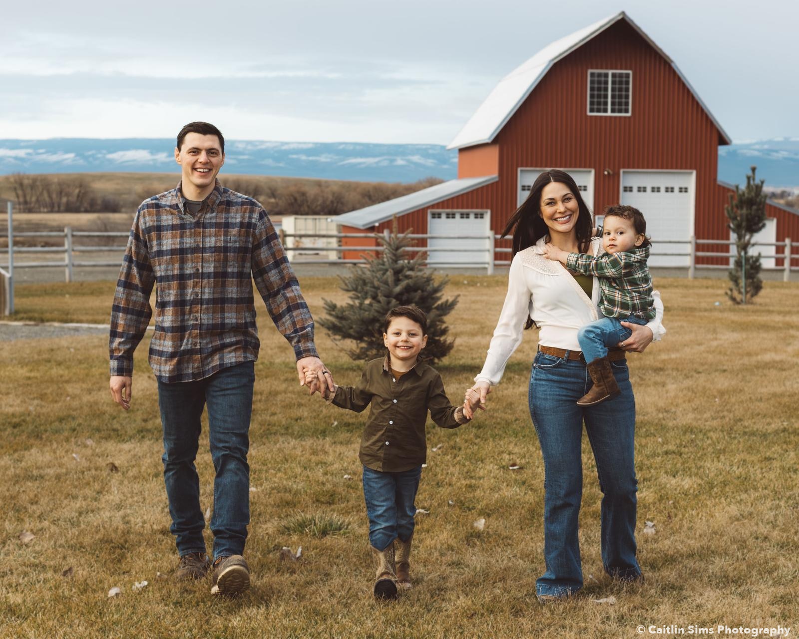 The Zazueta family in front of a red barn in Ellensburg, Washington — photo by Caitlin Sims Photography